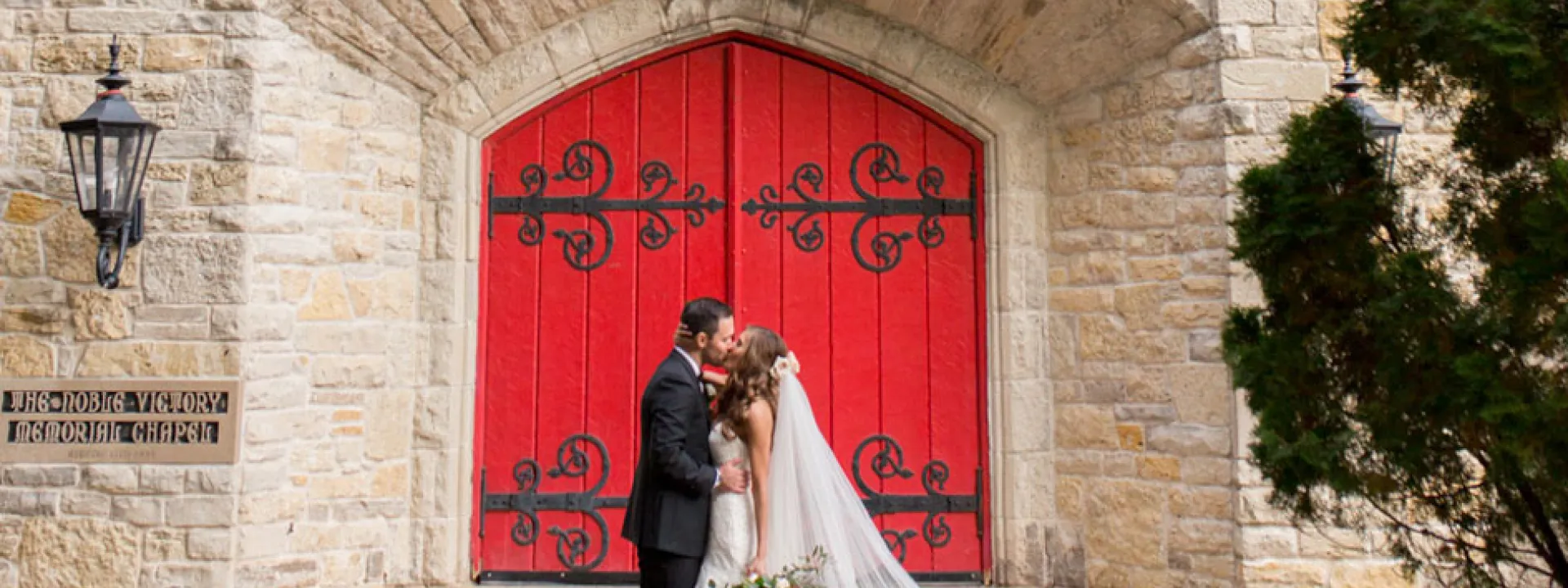 The couple embraces outside the historic stone church at St. John's Military Academy
