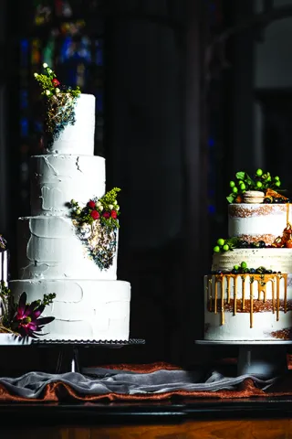 Four tiered wedding cakes with floral decorations and fruit toppings.