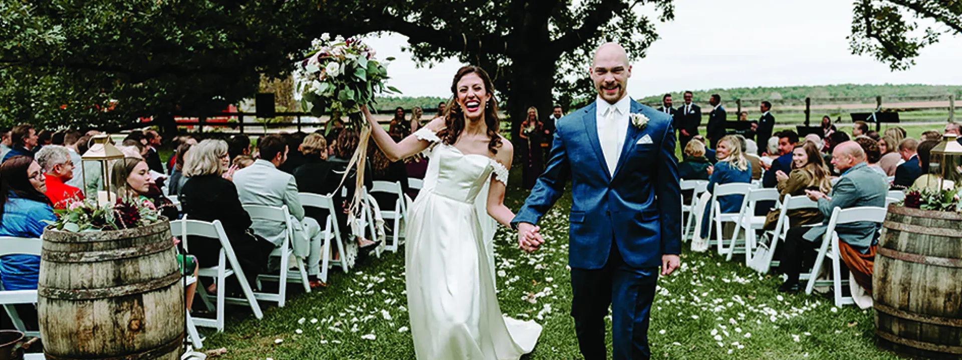 Caroline Grassl and Miles Groeschel walk down the aisle at their Sugarland Barn wedding.