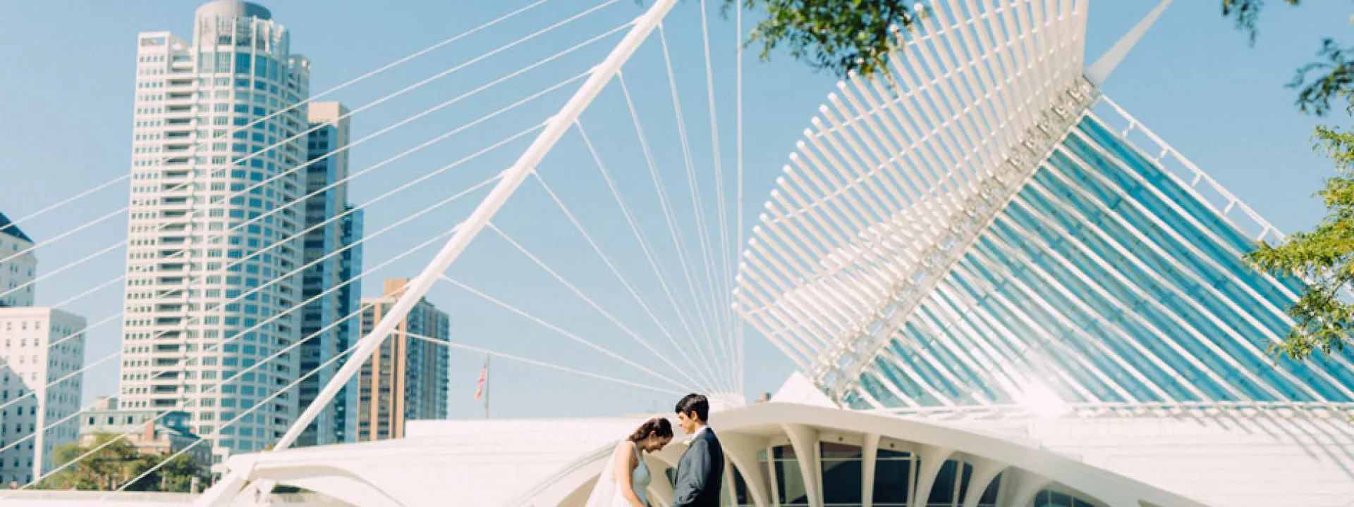 Bride and groom stand before the Quadracci Pavilion at the Milwaukee Art Museum