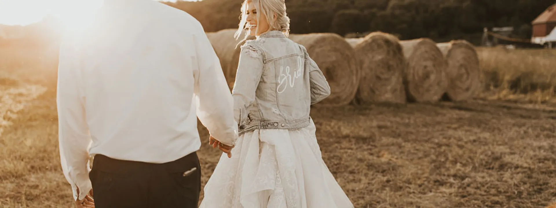 The bride shows her down-home style in a distressed and embellished bridal jean jacket.
